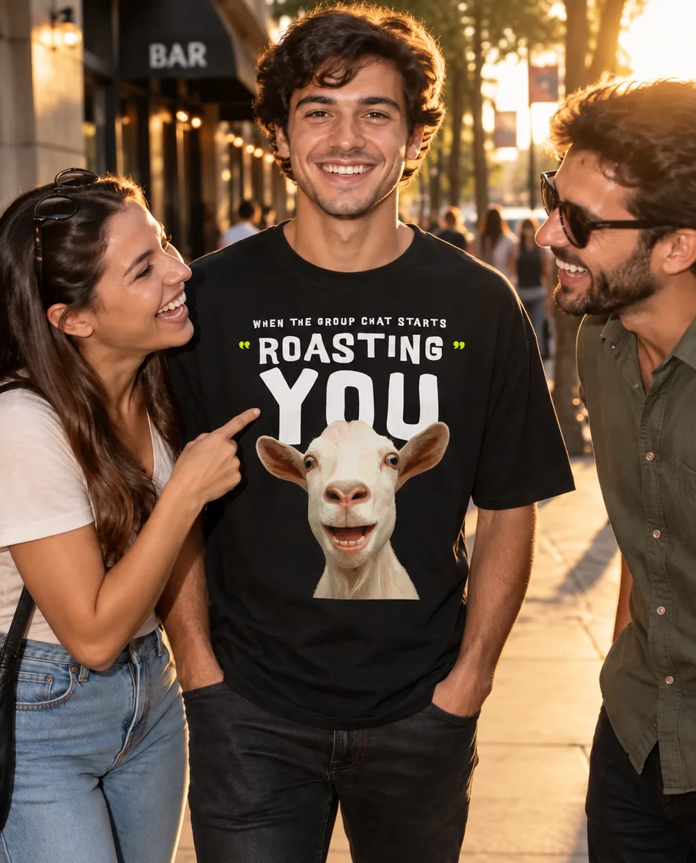 Three friends on a golden-hour street laughing as one points at the Roast design on a smiling man's black T-shirt